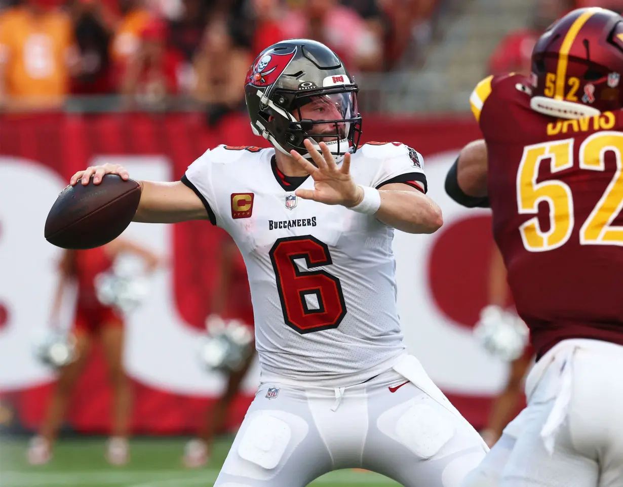 Mayfield throws the ball against the Washington Commanders.