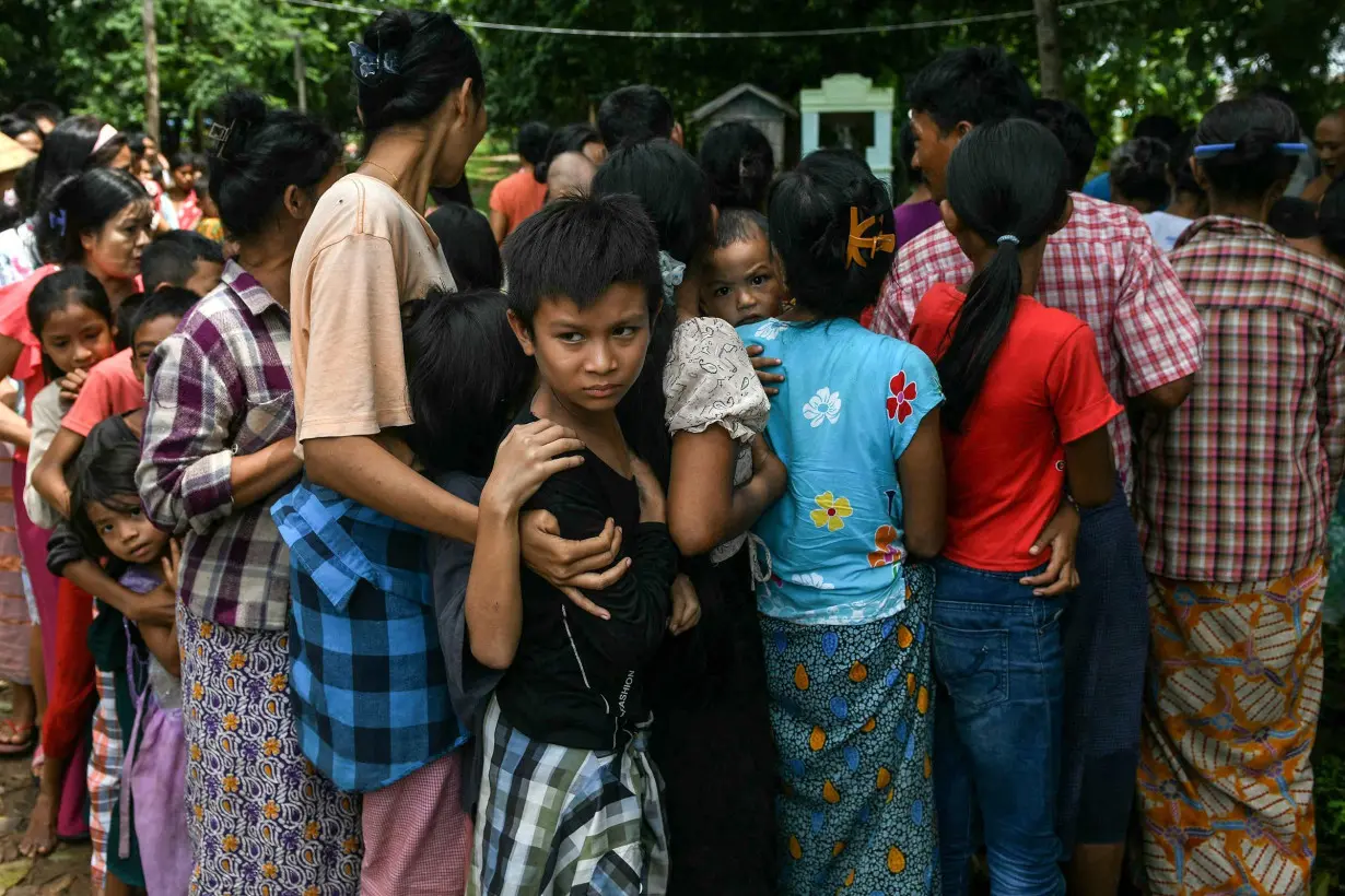 Flood-affected residents line up for food at a temporary camp in Taungoo, Myanmar, on September 14.