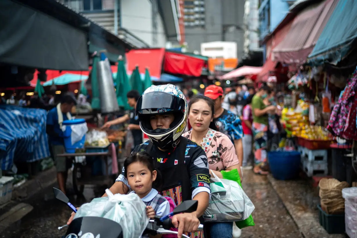 People shop at a market as Thailand is to inject $15.2 bln into economy next year through its digital wallet policy, in Bangkok