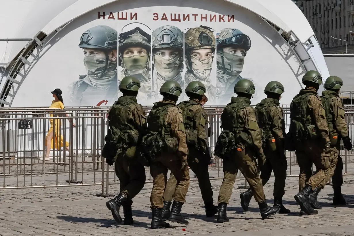 FILE PHOTO: Russian army servicemen walk at an exhibition displaying armoured vehicles and equipment captured by the Russian army from Ukrainian forces