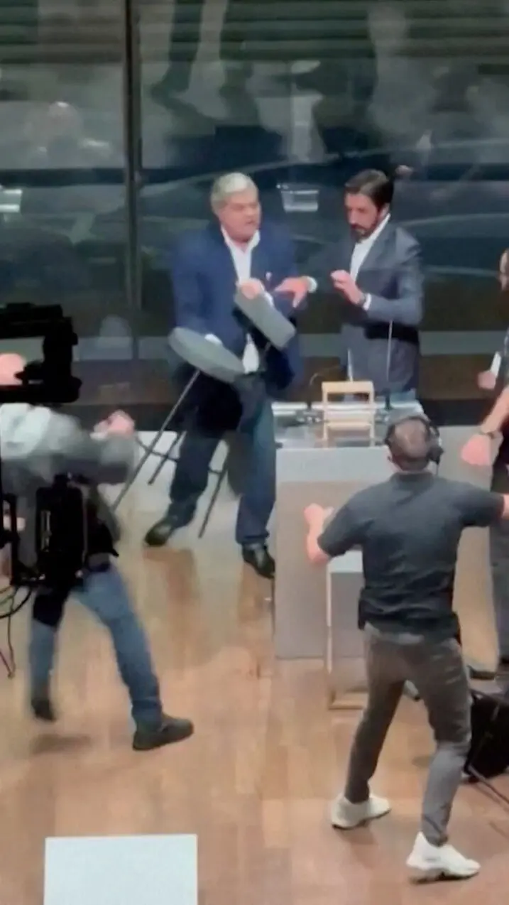 Candidate for Sao Paulo Mayor Jose Luiz Datena throws a chair at his opponent Pablo Marcal during a televised debate, in Sao Paulo