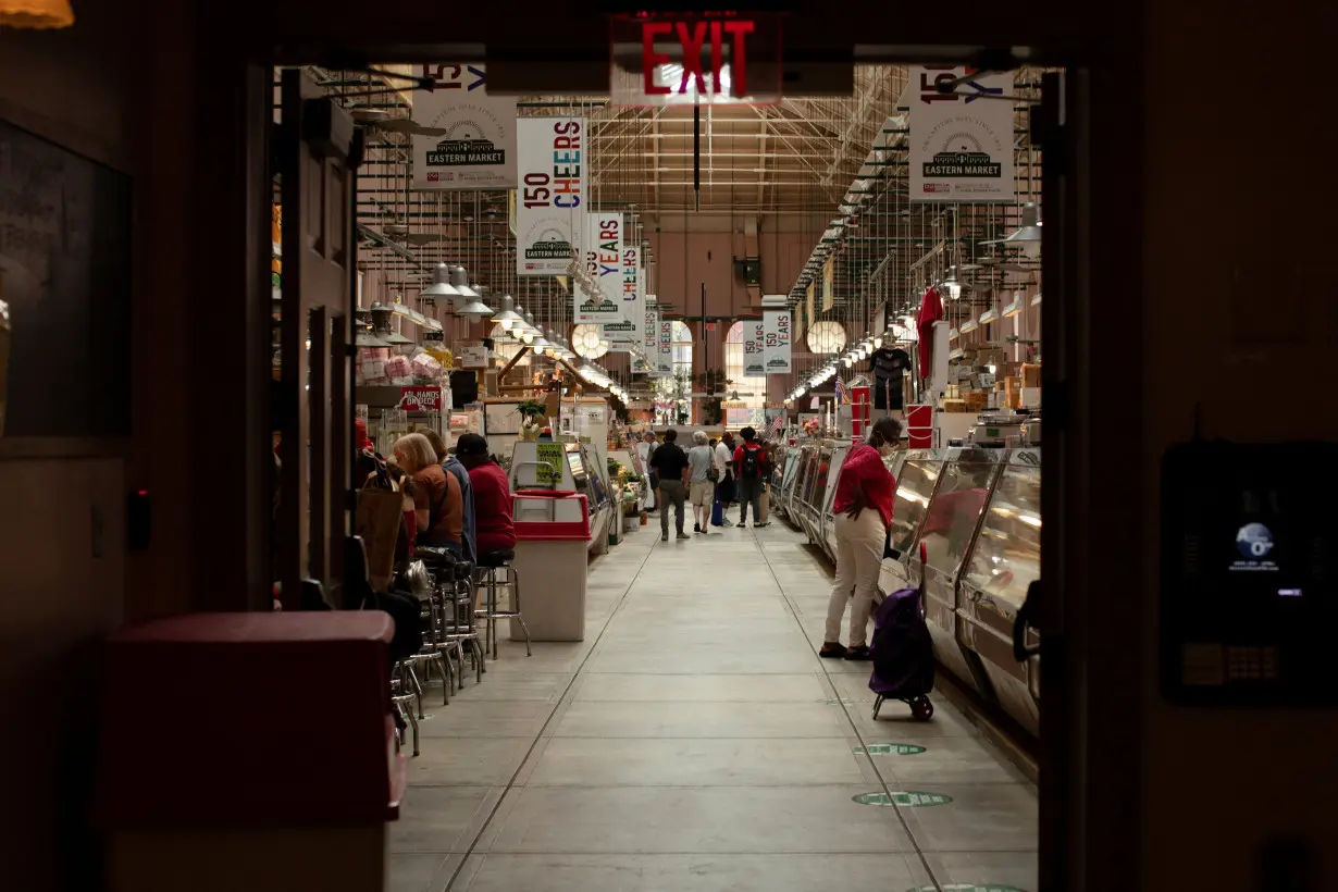 FILE PHOTO: People shop for groceries at Eastern Market in Washington