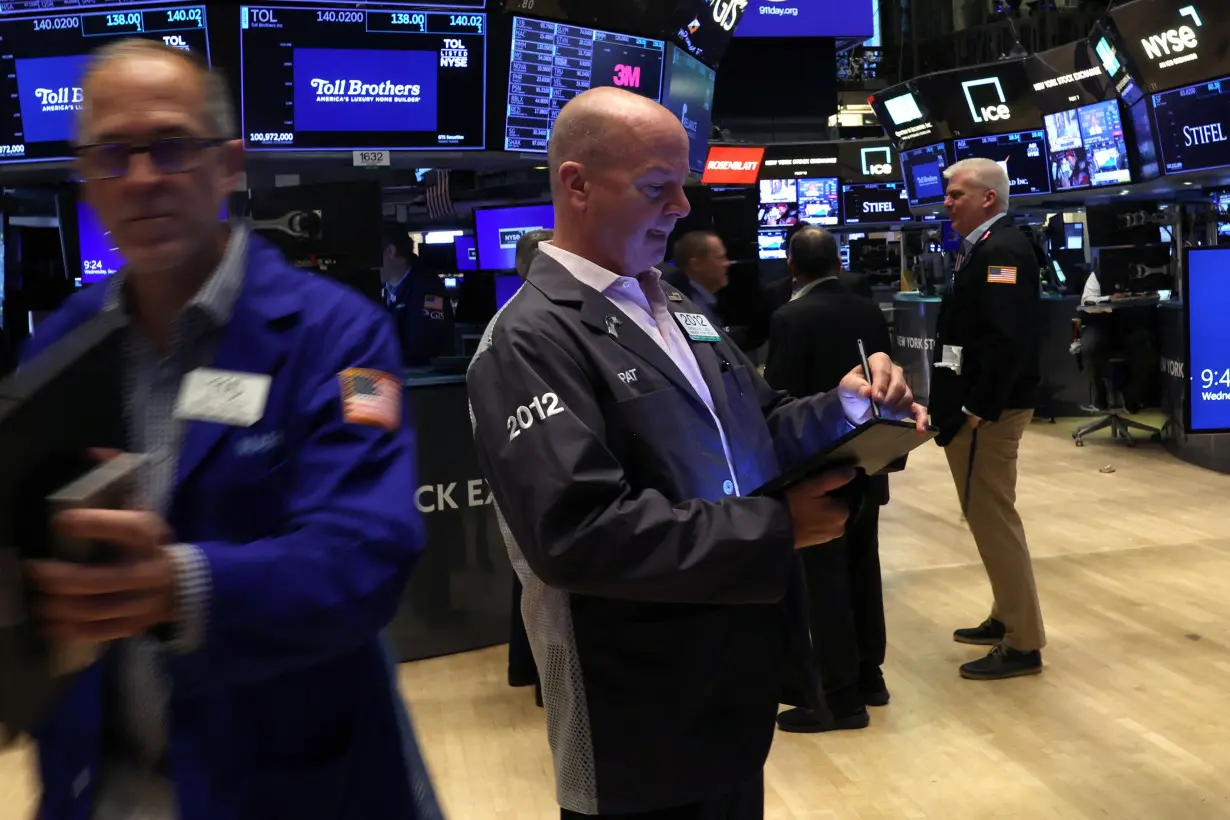 Traders work on the floor of the NYSE in New York