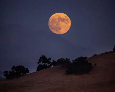 A partial eclipse took a ‘bite’ out of the harvest supermoon. See the stunning images