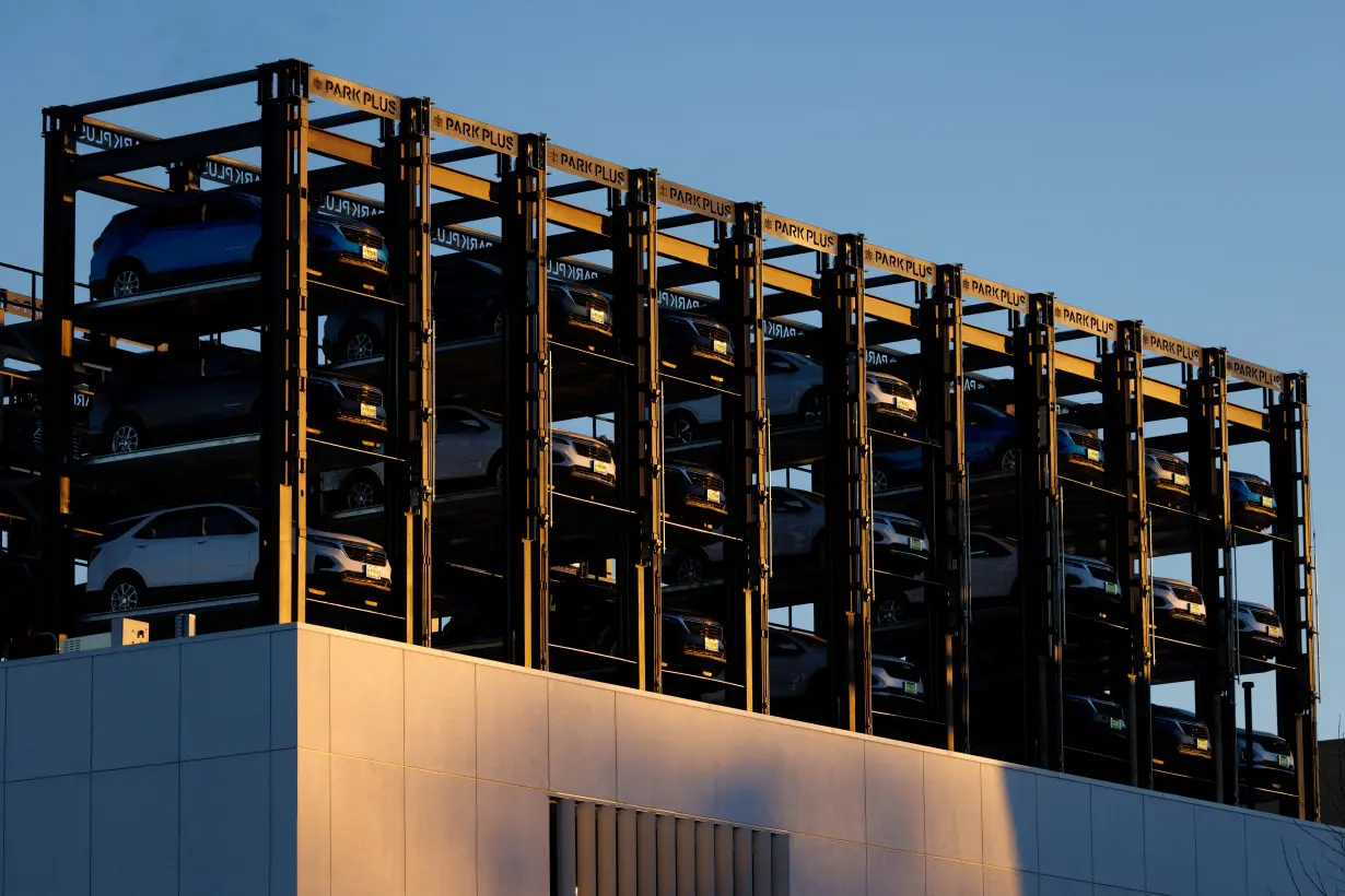 FILE PHOTO: An automobile dealership uses racks to store its inventory of vehicles in Los Angeles