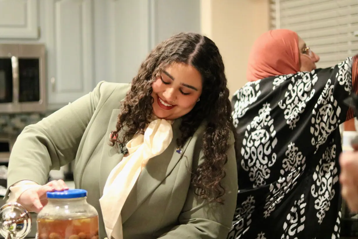 Zena Hajji opens a jar of her mother's homemade pickled olives at their home in Henderson, Nevada.