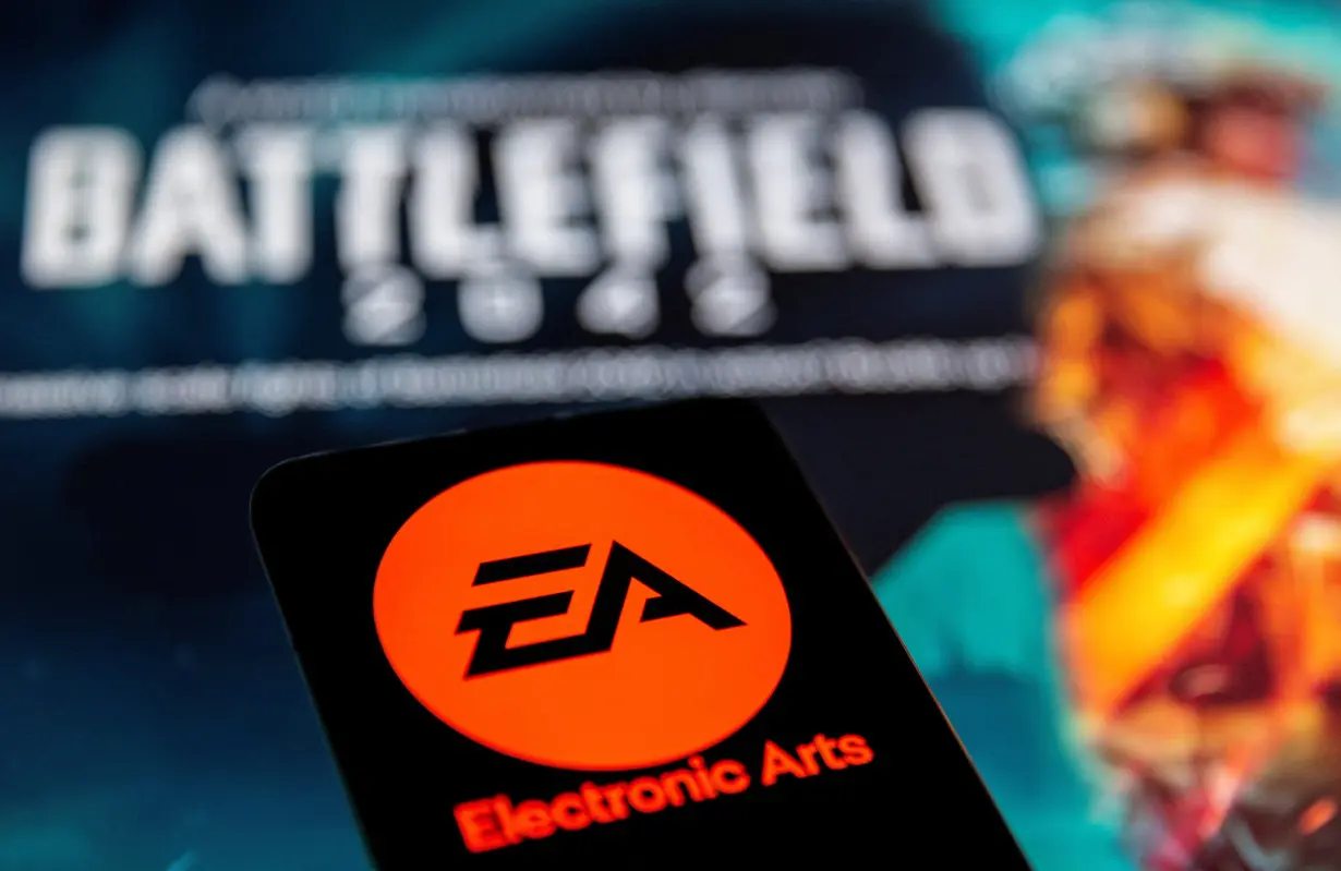 FILE PHOTO: A smartphone with the Electronic Arts logo is seen in front of a displayed 