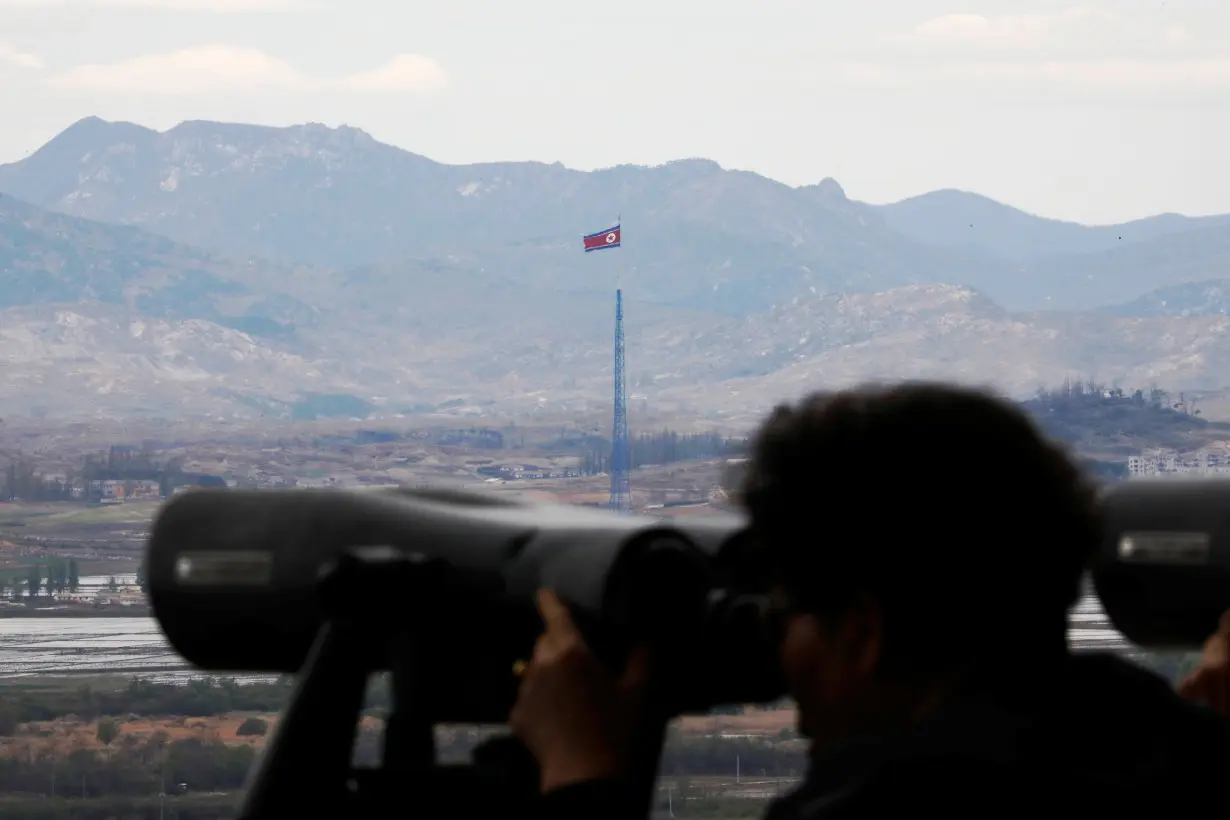 A North Korean flag flutters on top of a 160-metre tower in North Korea's propaganda village of Gijungdong in this picture taken from the Dora observatory near the demilitarised zone separating the two Koreas, in Paju