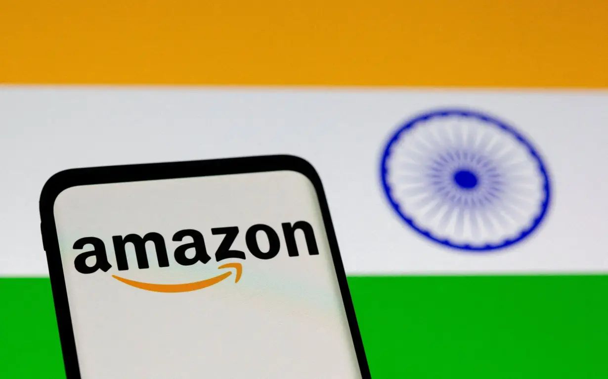 FILE PHOTO: Smartphone with Amazon logo is seen in front of displayed Indian flag in this illustration