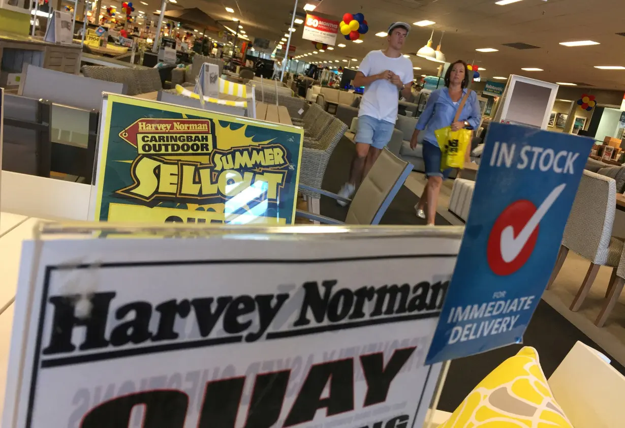 FILE PHOTO: Shoppers walk the furniture showroom at a Harvey Norman outlet in Sydney