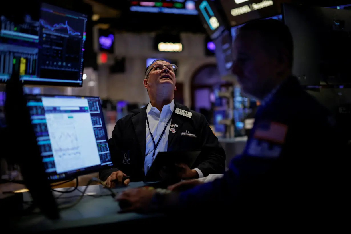 Traders work on the floor of the NYSE in New York