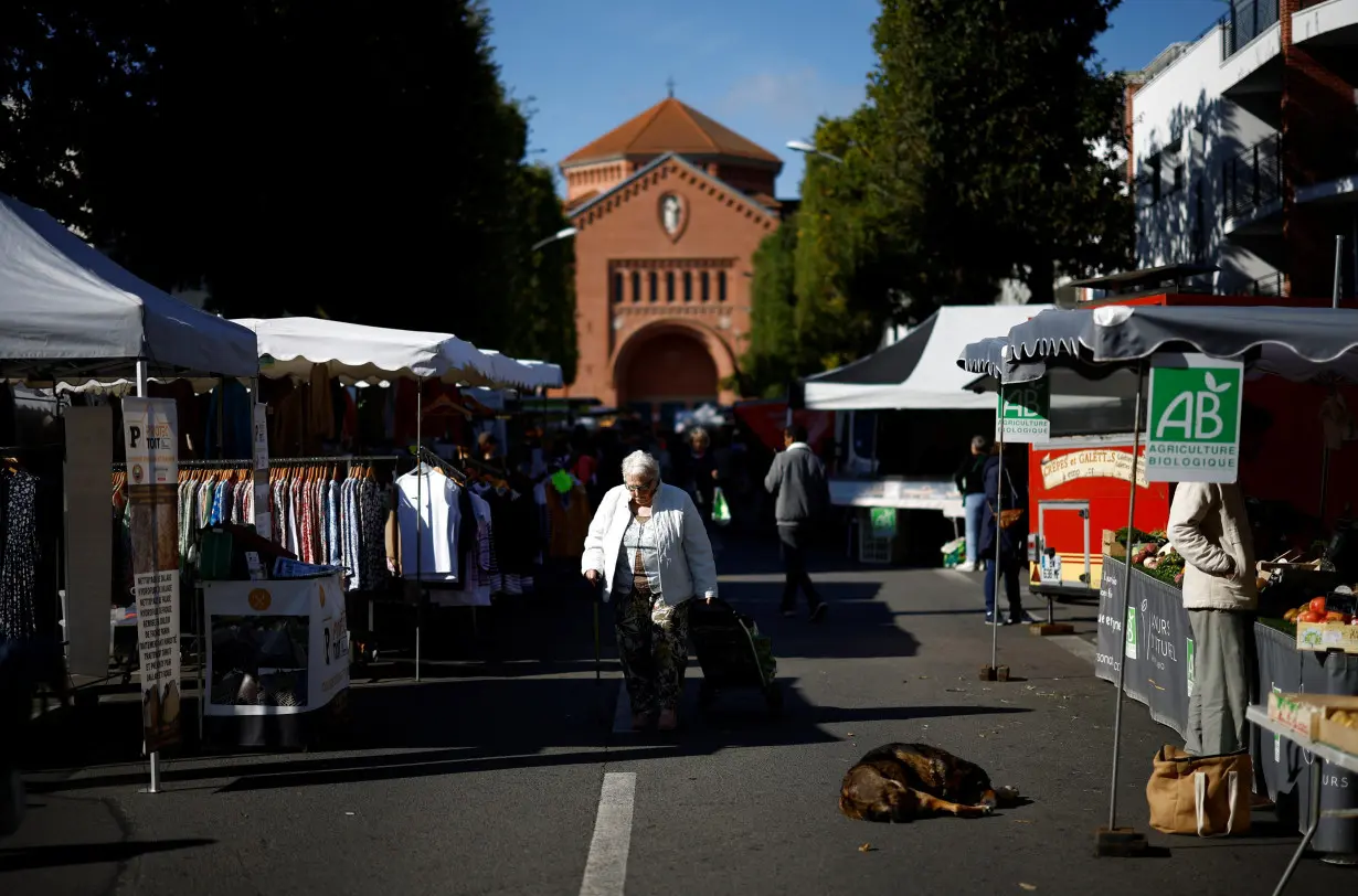 A woman walks at a local market in Nantes