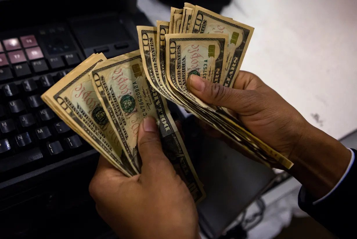 A cashier counts out money at Macy's Herald Square on Thanksgiving Day in New York