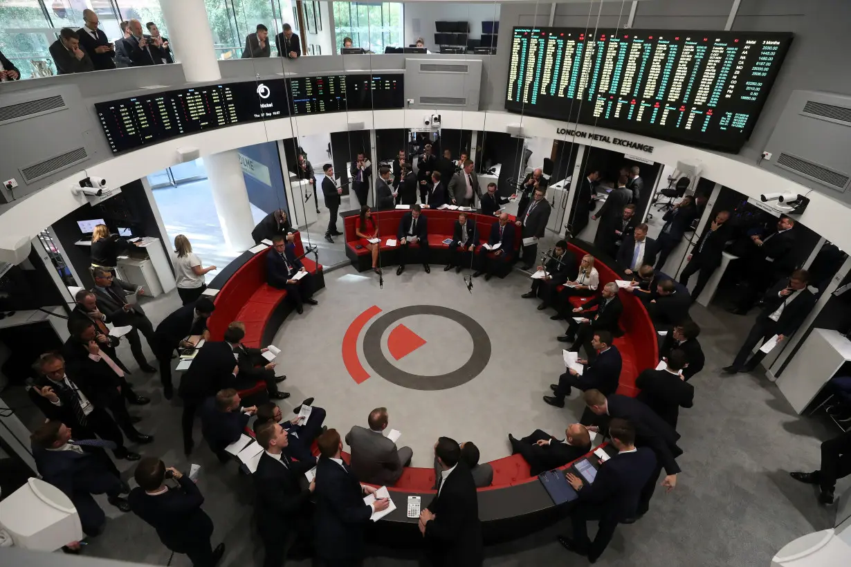 Traders work on the floor of the London Metal Exchange, in London