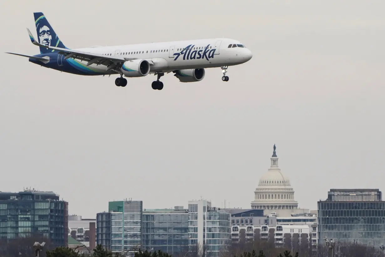 An Alaska Airlines aircraft lands at Reagan National Airport in Arlington, Virginia