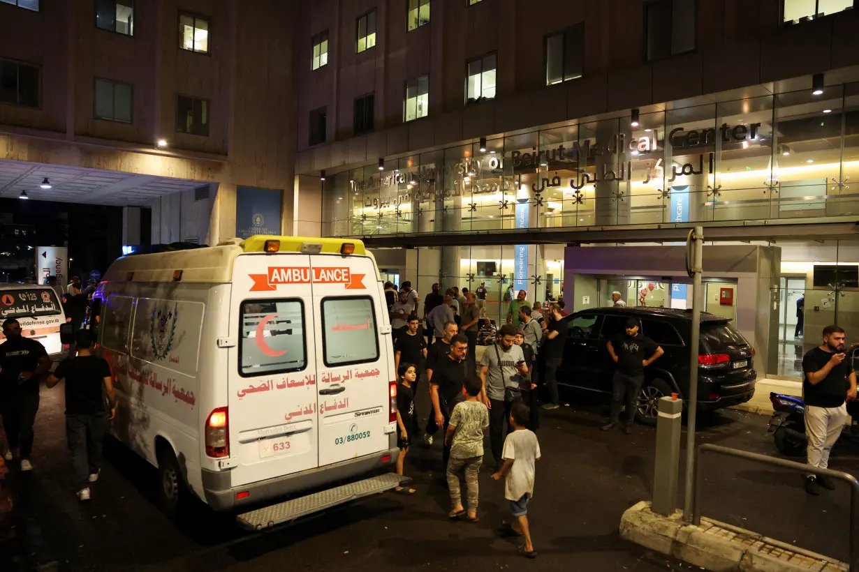 People walk near an ambulance outside American University of Beirut Medical Center, including Hezbollah fighters and medics, were wounded and killed when the pagers they use to communicate exploded across Lebanon, according to a security source, in Beirut