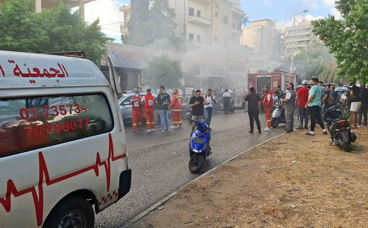 Smoke rises from a mobile shop in Sidon, south of Beirut, on September 18.