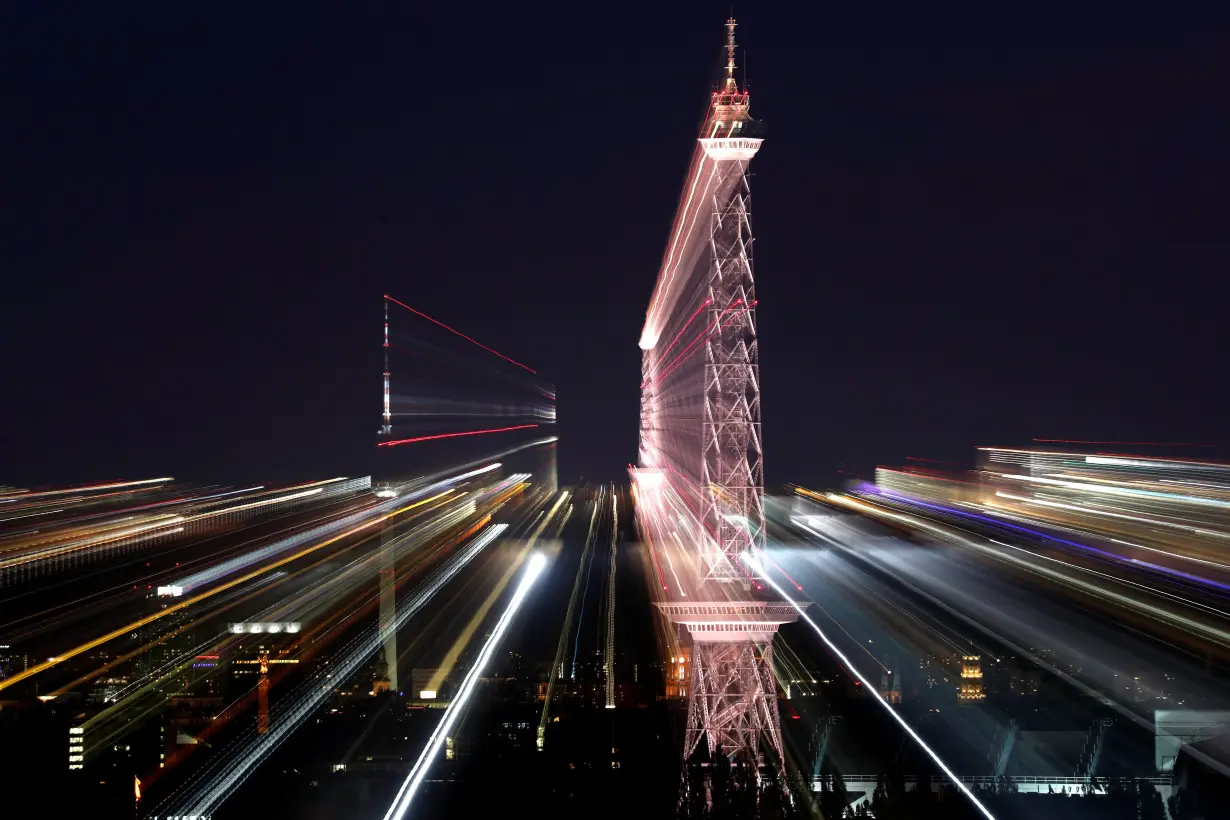 The city's skyline is pictured with the TV tower (Fernsehturm) and radio tower (Funkturm) during the evening in Berlin