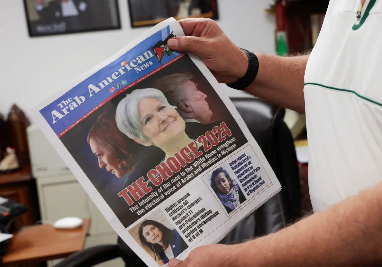 The Arab American News publisher Osama Siblani shows the newspaper cover with the lead story of 'the electoral voice of Arabs and Muslims in Michigan' in Dearborn