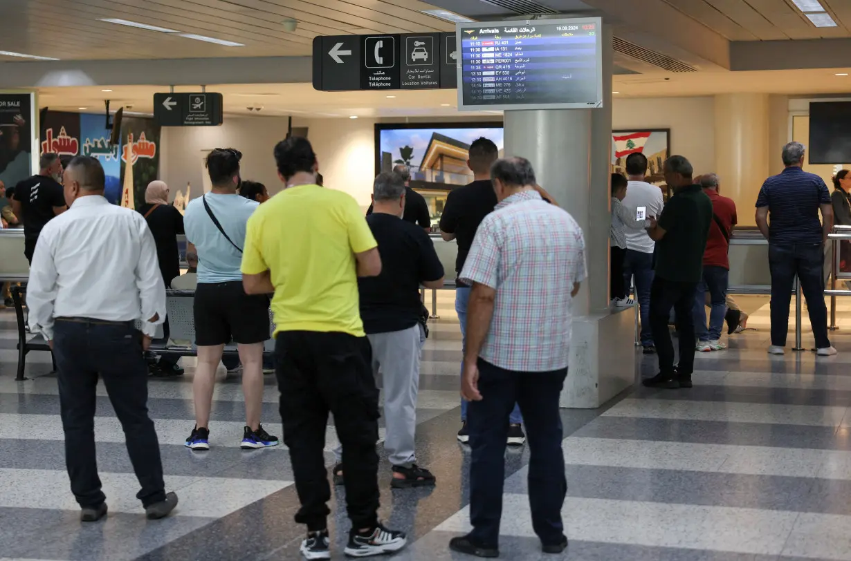 People stand at Beirut-Rafic Hariri International Airport, in Beirut