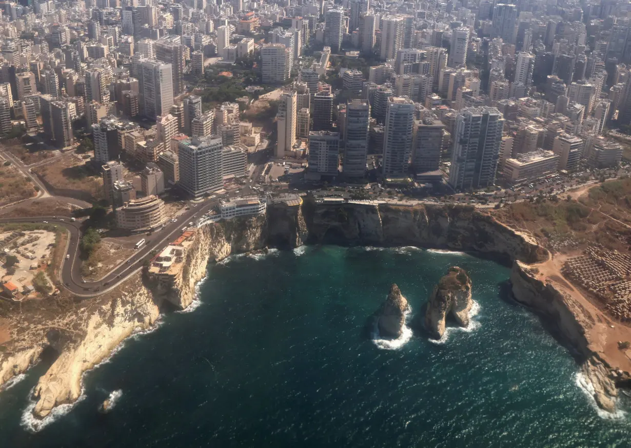 An aerial view from an airplane window shows the coast and the Raouche Rock with a general view of the Lebanese capital Beirut