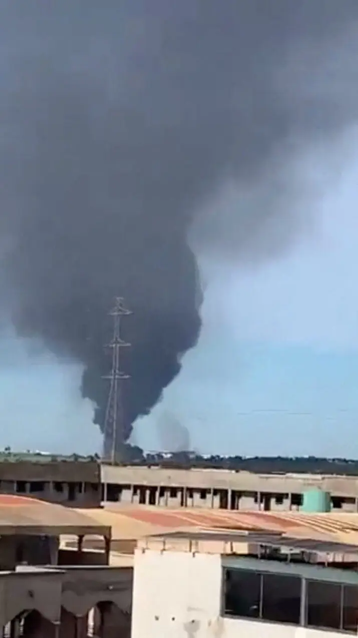 Smoke rises from the international airport that was attacked by insurgents in Bamako