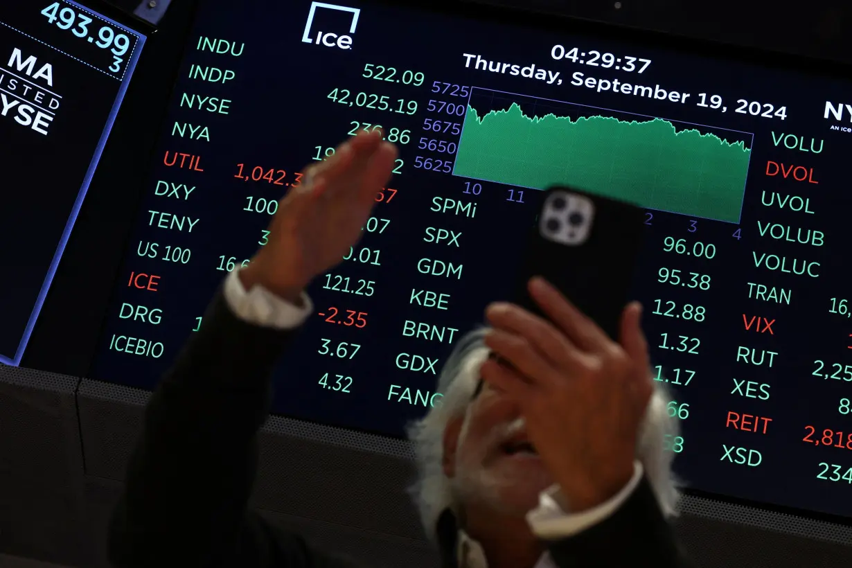 A screen displays the Dow Jones Industrial Average on the floor of the NYSE in New York