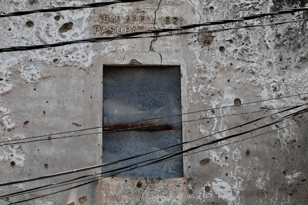 A close-up view of bullet holes on the wall of an old house standing before Sri Lanka's 27-year-long civil war, on a street in Jaffna