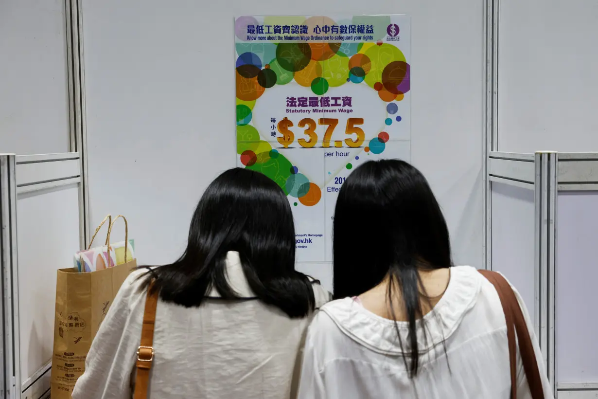 Job seekers wearing face masks fill in forms at the Wan Chai Job Fair, following the coronavirus disease (COVID-19) outbreak, in Hong Kong