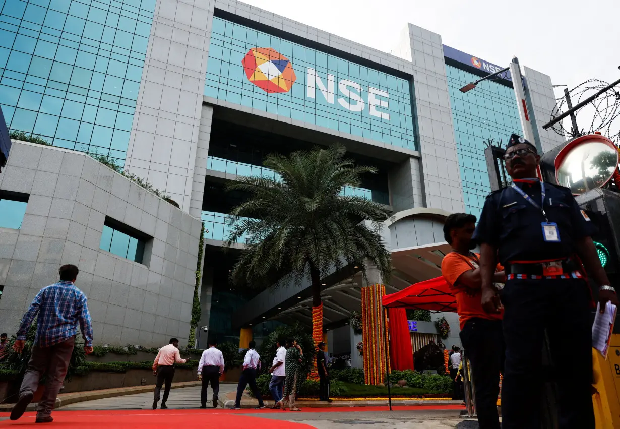 A guard stands at the gate of the National Stock Exchange (NSE) in Mumbai