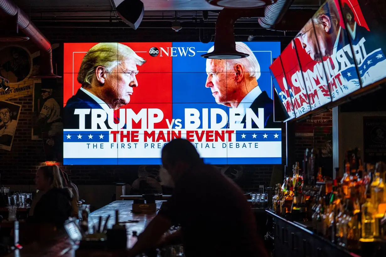 Television screens airing a presidential debate at a sports bar in Washington, DC in 2020.