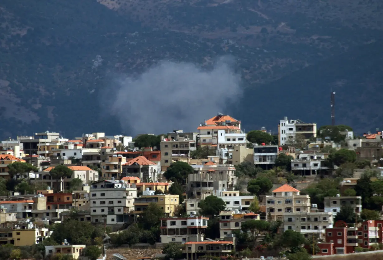 Smoke rises from the southern Lebanese village of Khiam as pictured from Marjayoun