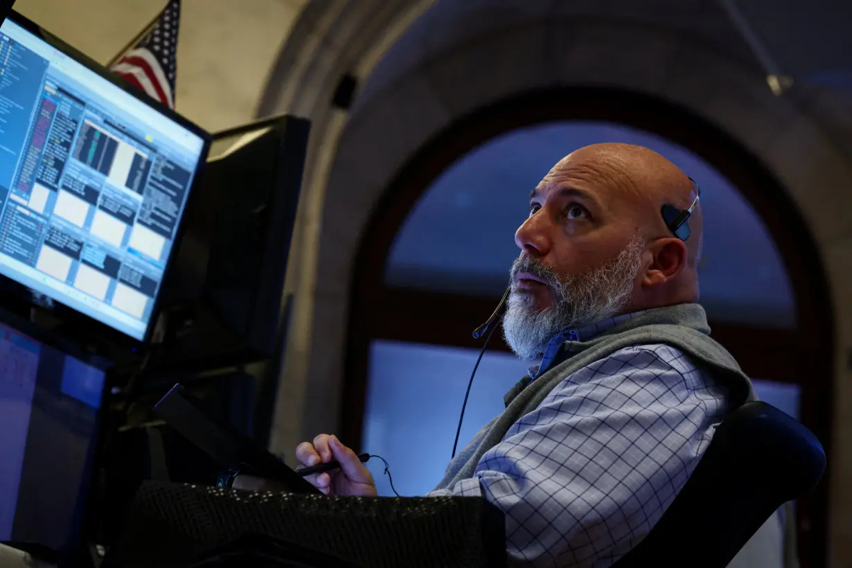 Traders work on the floor of the NYSE in New York