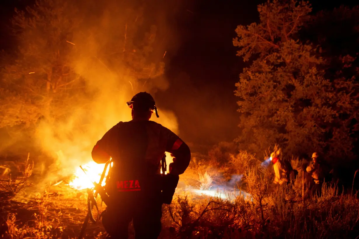 FILE PHOTO: Cal Fire firefighters are shown tackling one of many wildfires in California this year