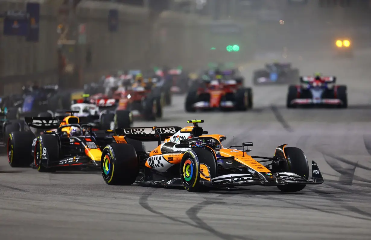 McLaren's Lando Norris leads into the first corner at the start of the race.