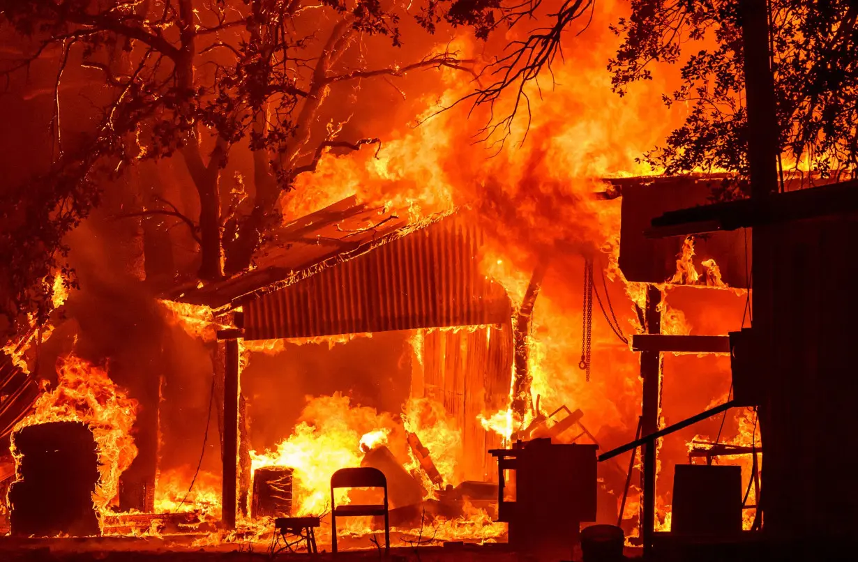 A property is seen burning in the flames of Park fire in Tehama County, California.