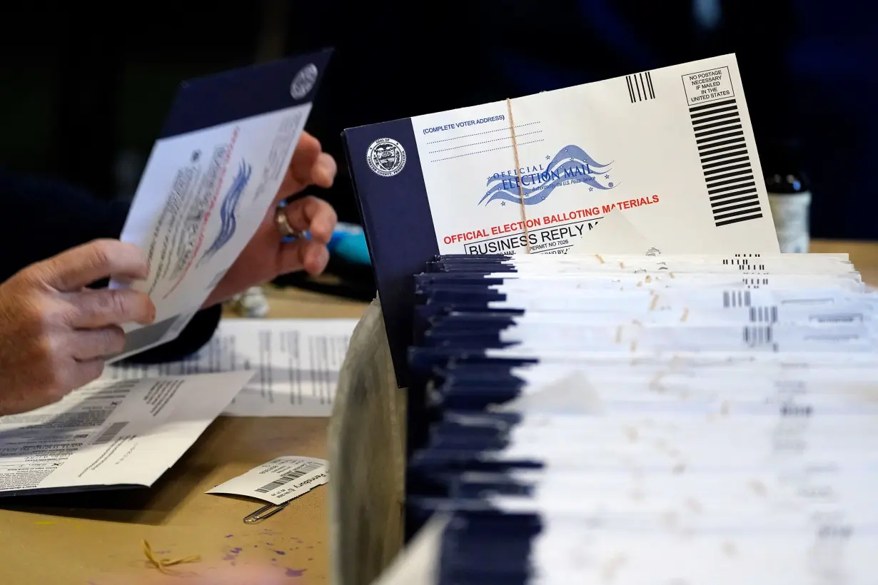 Election workers process mail-in and absentee ballots in West Chester, Pennsylvania, on November 4, 2020.