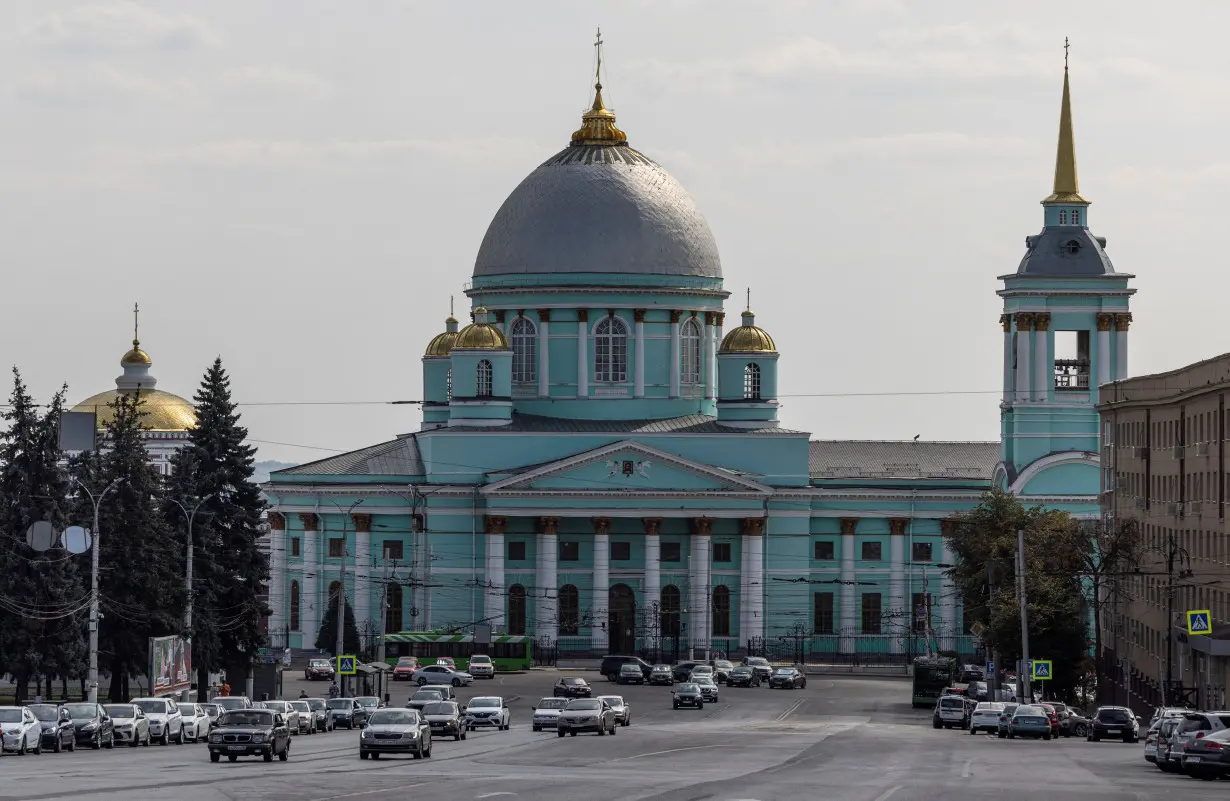 Cars drive in front of the Znamensky Cathedral in Kursk