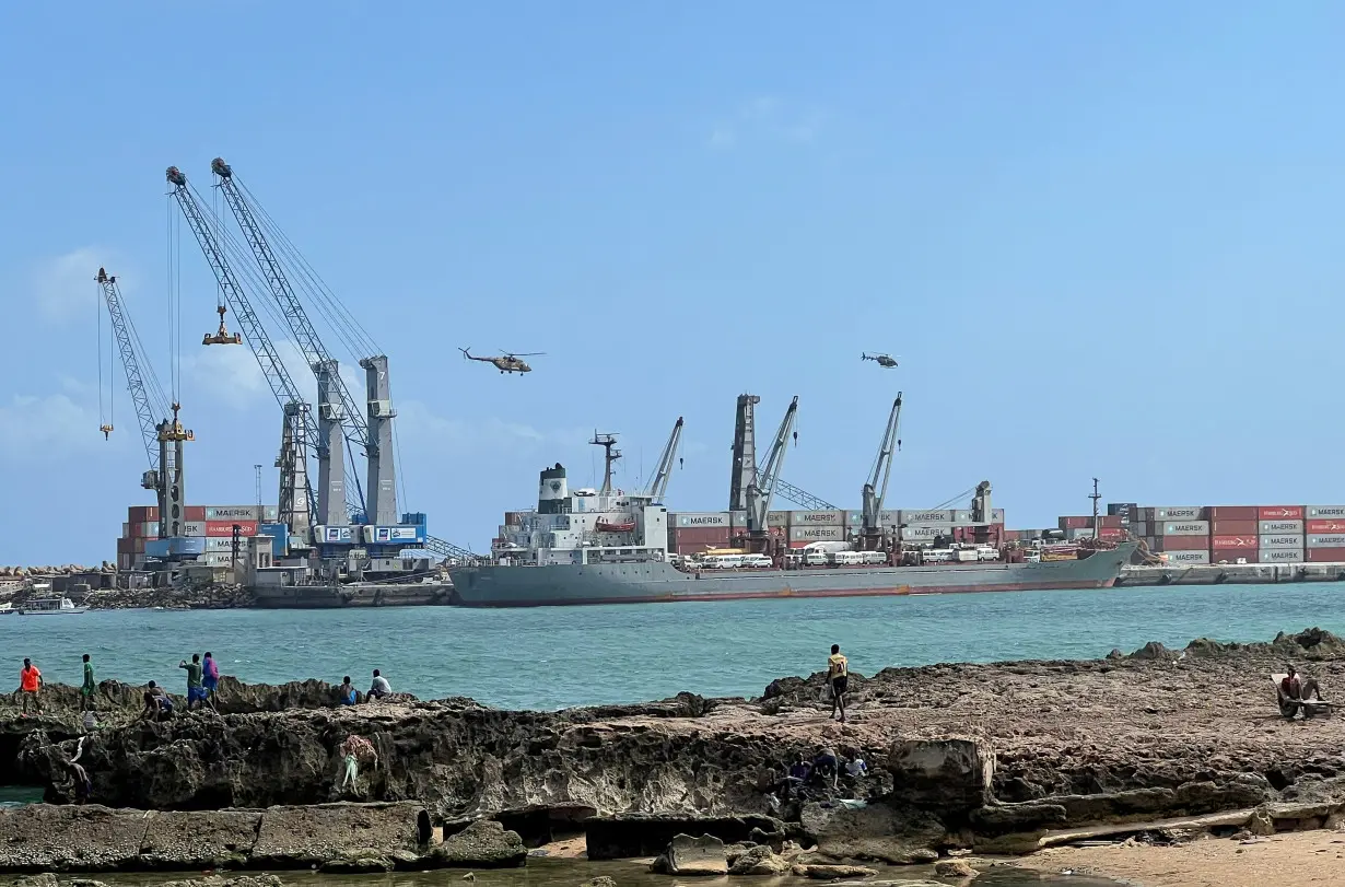 Security helicopters hover above the Mogadishu Sea Port after an Egyptian warship docked to deliver a second major cache of weaponry in Mogadishu