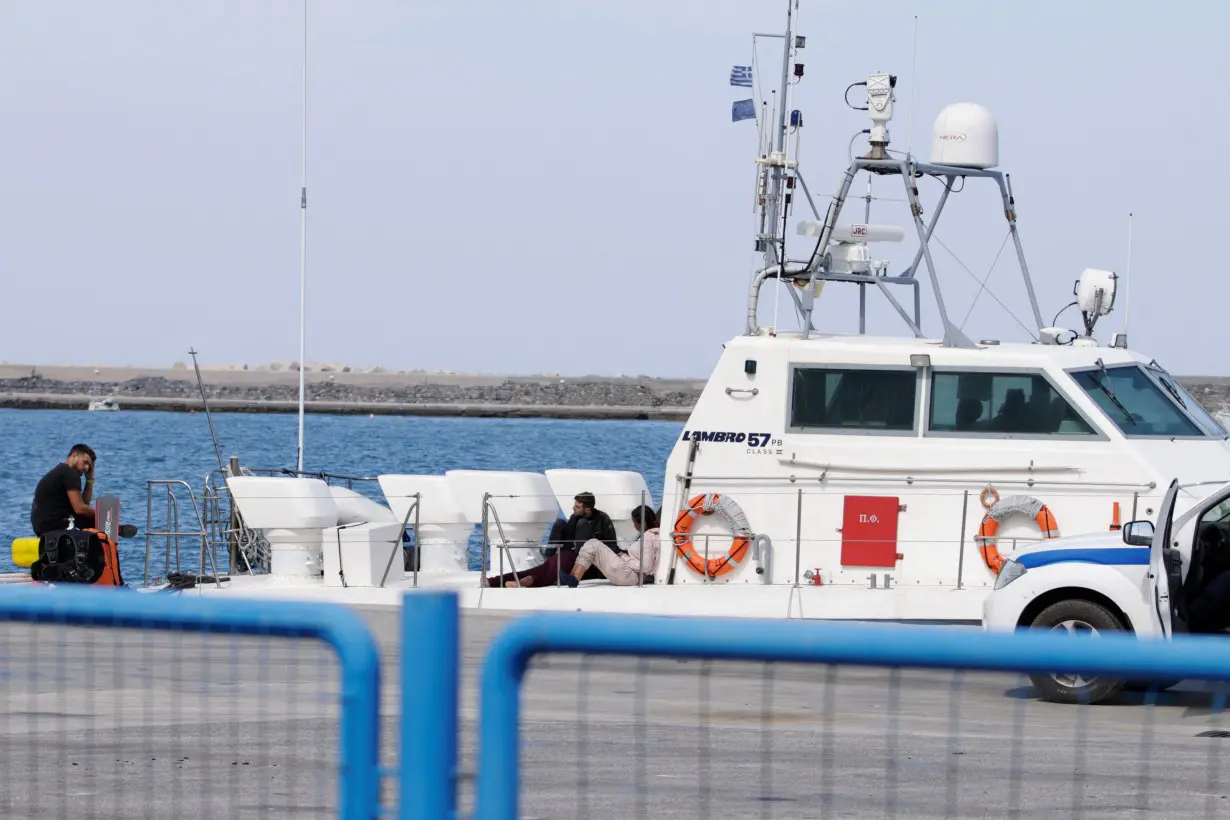 Rescued migrants are seen onboard a Hellenic Coast Guard vessel, following a SAR operation, at the port of Karlovasi, on the island of Samos