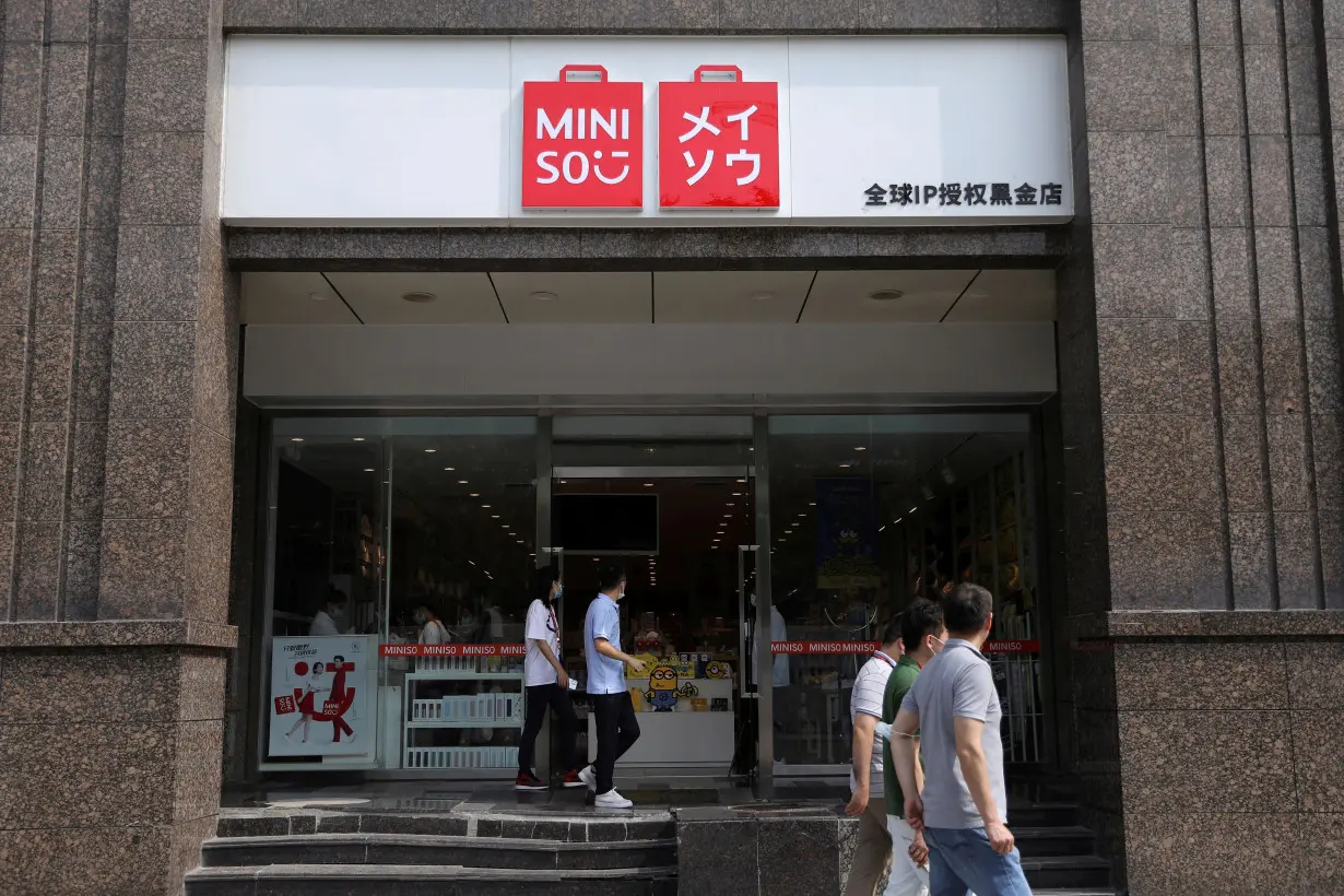 FILE PHOTO: People walk past a store of Chinese retailer MINISO Group in Beijing