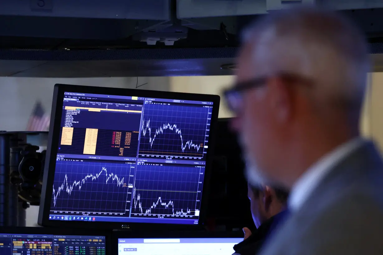 Traders work on the floor of the NYSE in New York