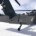 A snowmobiler who crashed into a parked Black Hawk helicopter is awarded $3 million