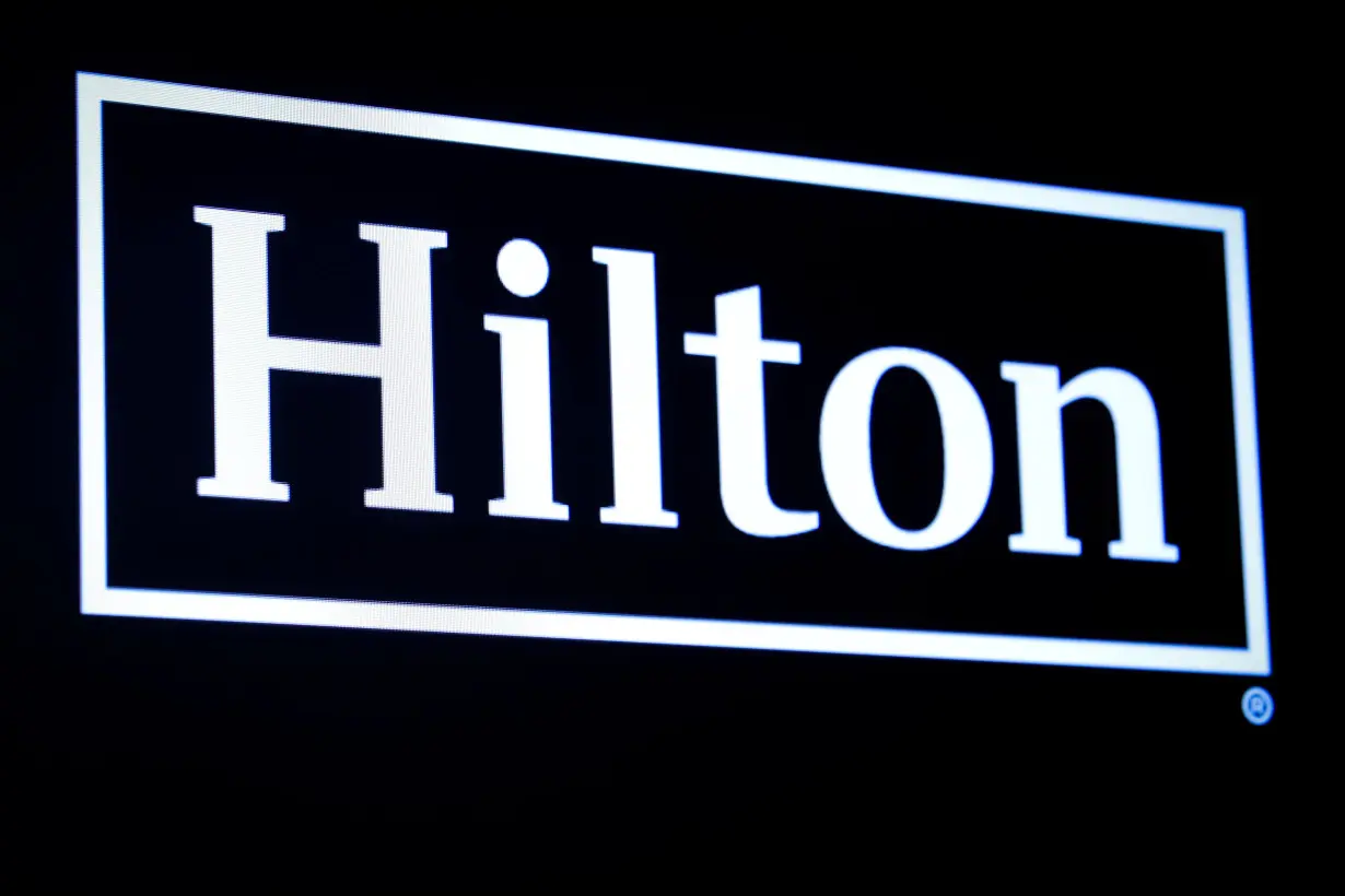 The Hilton logo is displayed on a screen on the floor of the NYSE in New York