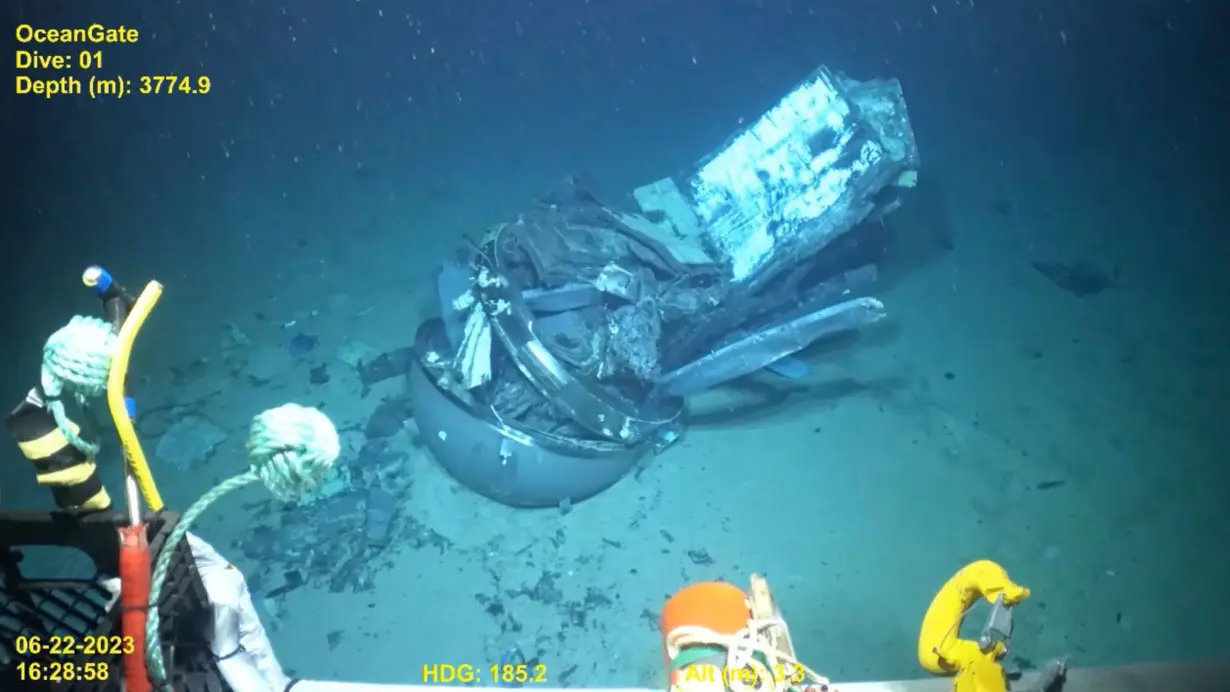 This June 2023 video still frame shows remains of the Titan submersible, center, on the floor of the Atlantic Ocean.