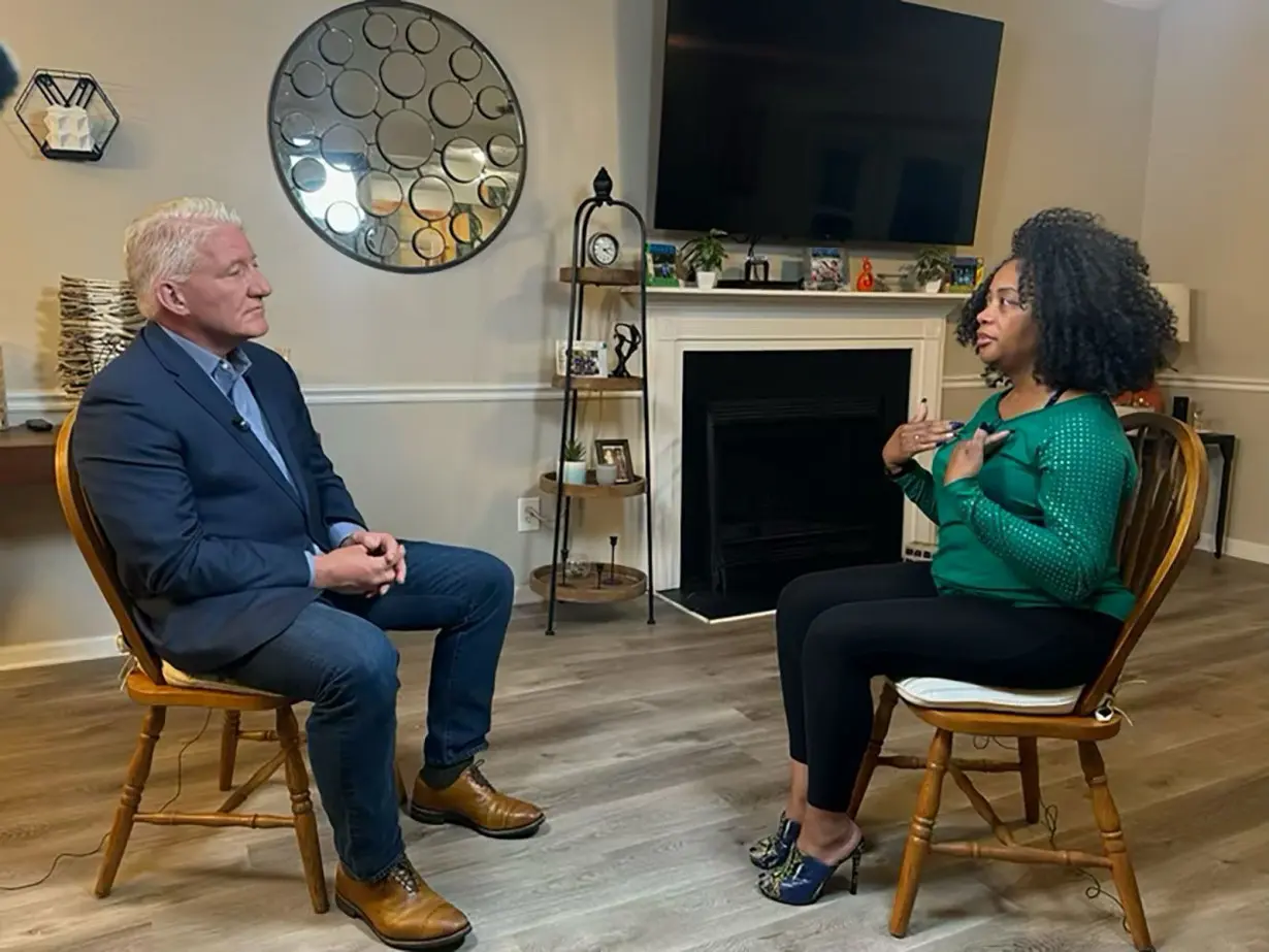 Georgia voter Chantá Villano-Willis talks with John King in Powder Springs, Georgia.