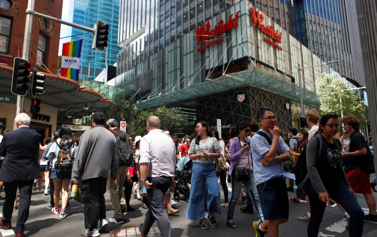 Pedestrians walk past a Westfield shopping mall in Sydney