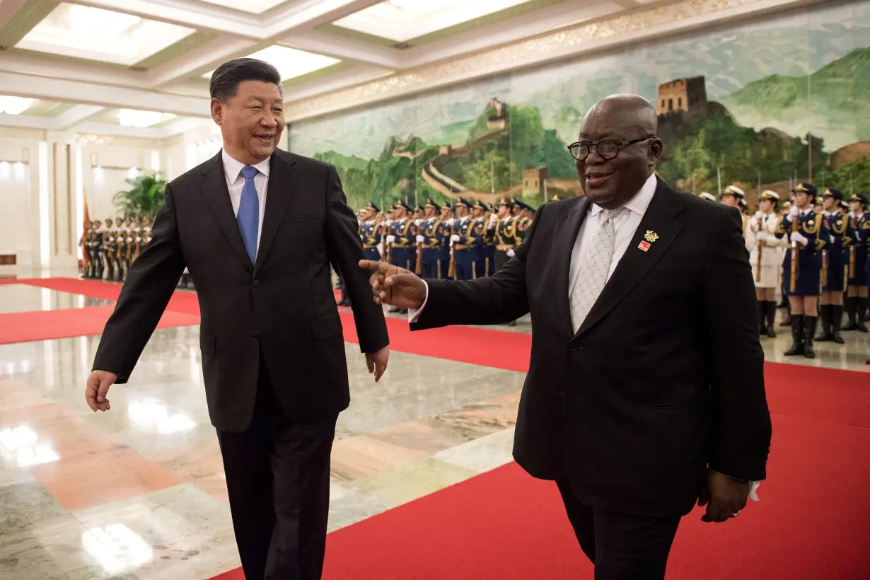 FILE PHOTO: China's President Xi Jinping and Ghana President Nana Akufo-Addo review the Chinese People's Liberation Army honour guard during the welcome ceremony at the Great Hall of the People