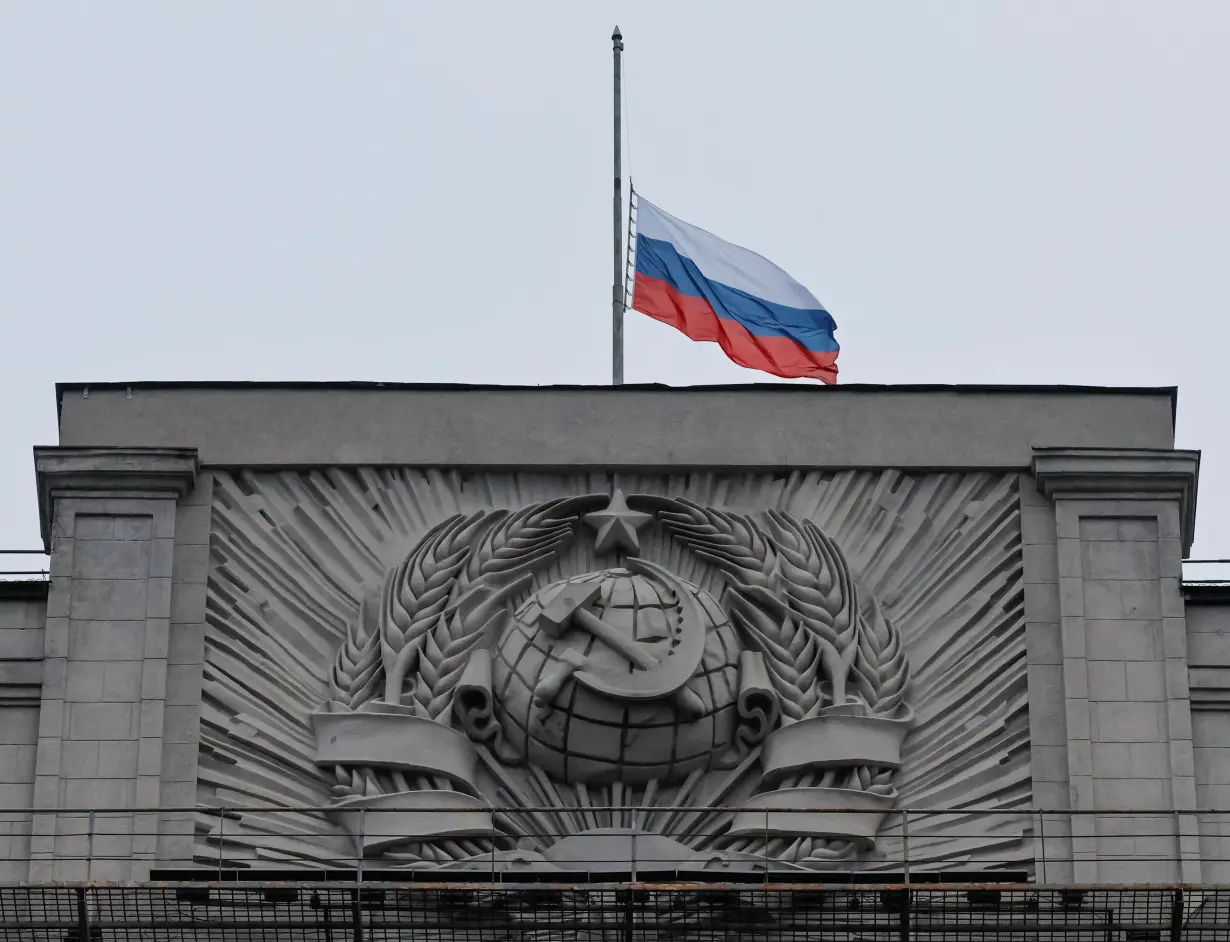 FILE PHOTO: A Russian national flag is seen lowered on the headquarters of State Duma