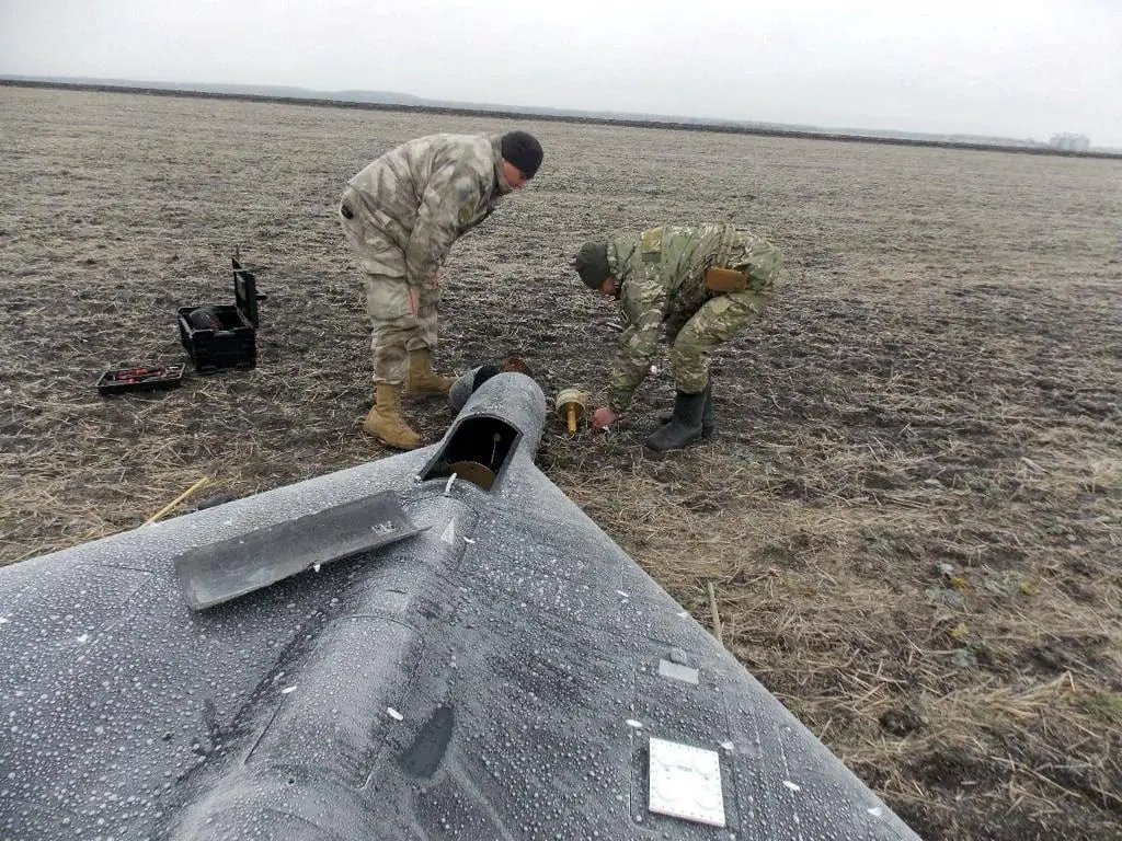 FILE PHOTO: Members of police demining unit remove a warhead from a Russian kamikaze unmanned aerial vehicle landed by a radio electronic warfare during one of latest drone strikes in an unknown location in Ukraine